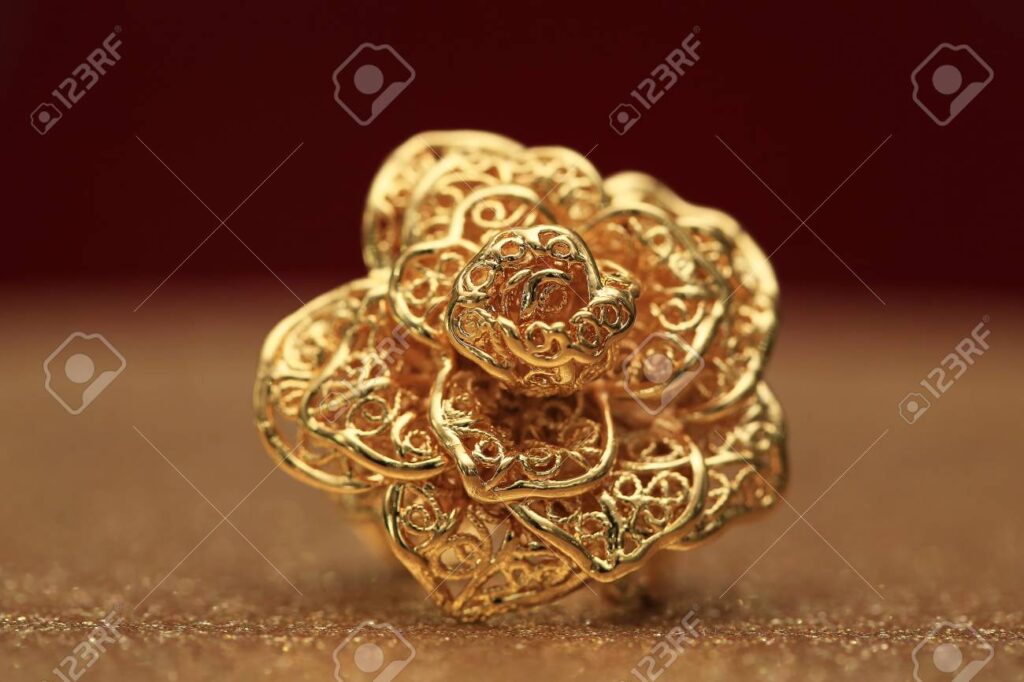 Gold Rose Flower Ring On Glitter Background